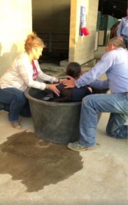 Lee Francois baptizing Sadie with his wife Holly